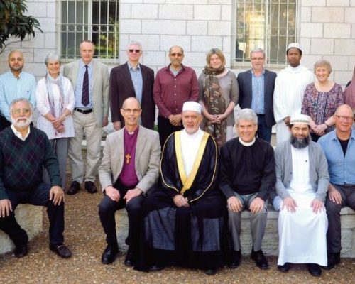 Group photo of the “Sharing Perspectives: Muslims and Christians in the Holy Land” outside St George’s College Jerusalem. Row 1: Bishara Khoury, Bishop Richard Cheetham, Dr. Mustafa Abu Sway, Dr. Gregory Jenks, Shaykh Ibrahim Mogra, Rodney Aist, Umar Qureshi. Row 2: Fr. Falak Sher, Manzoor Ahmed Shakir, Asif Sadiq, Diana Mills, Rev. Ken Walker, Adrian Holdstock, Jamil Hashim, Rev. Catherine Tucker, Dave Hanson, Lamine Konate, Eileen Eggington, Sughra Ahmed.