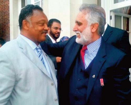 Senator Rev. Jesse Jackson gives a hearty embrace during a reception at the residence of US Ambassador HE Matthew Barzun in London.